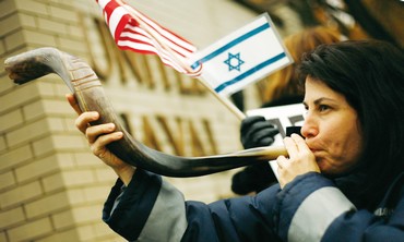 Woman blows shofar