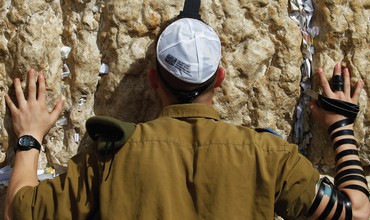 A soldier prays at the Western Wall. ‘