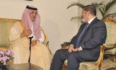 Egypt's President Mohamed Morsi (R) meets with Saudi Arabia's Foreign Minister Prince Saud al-Faisal