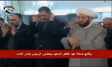 Assad attends Eid al-Fitr prayers in Damascus following reports his convoy was targeted.