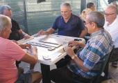 RESIDENTS OF Little Havana pass the time playing dominoes.