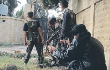 Syrian rebels take up positions during clashes with forces loyal to President Assad near Aleppo.