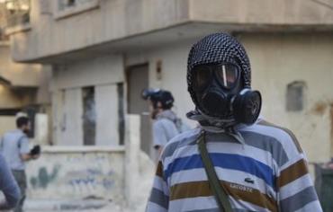A Syrian activist wearing a gas mask where chemical weapons were allegedly used near Damascus. 