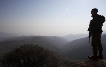 IDF soldier looking over Jordan Valley.