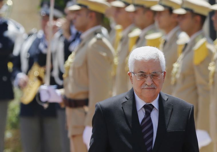 Palestinian President Mahmoud Abbas walks with Italy's Prime Minister Matteo Renzi (unseen)