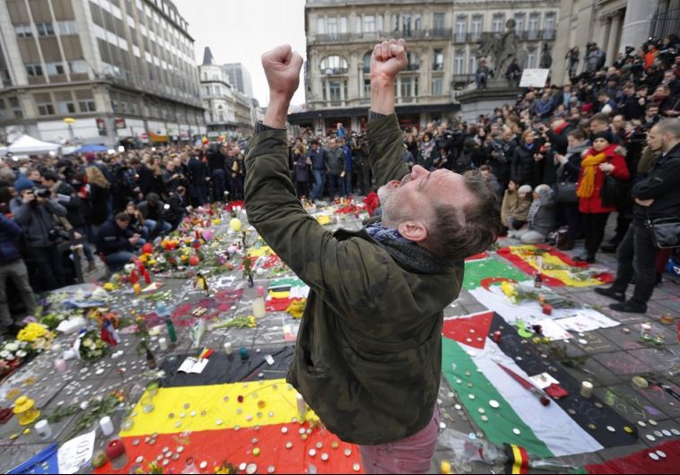 A man reacts at a street memorial following Tuesday's bomb attacks in Brussels