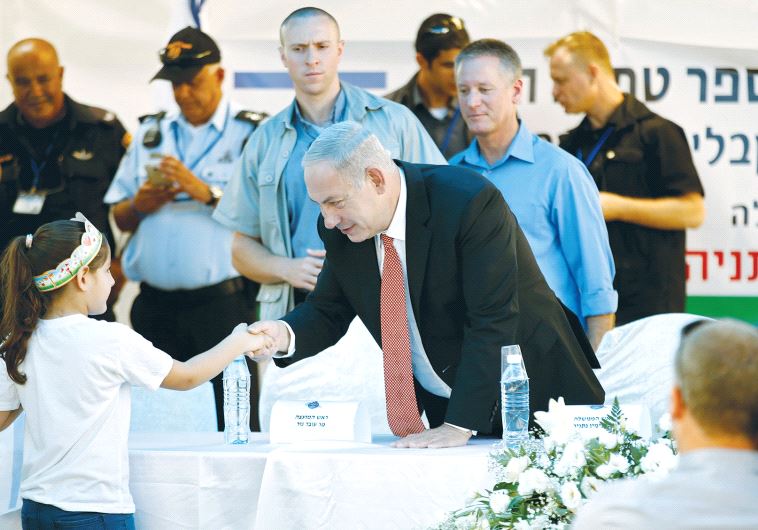 Netanyahu greets school children.