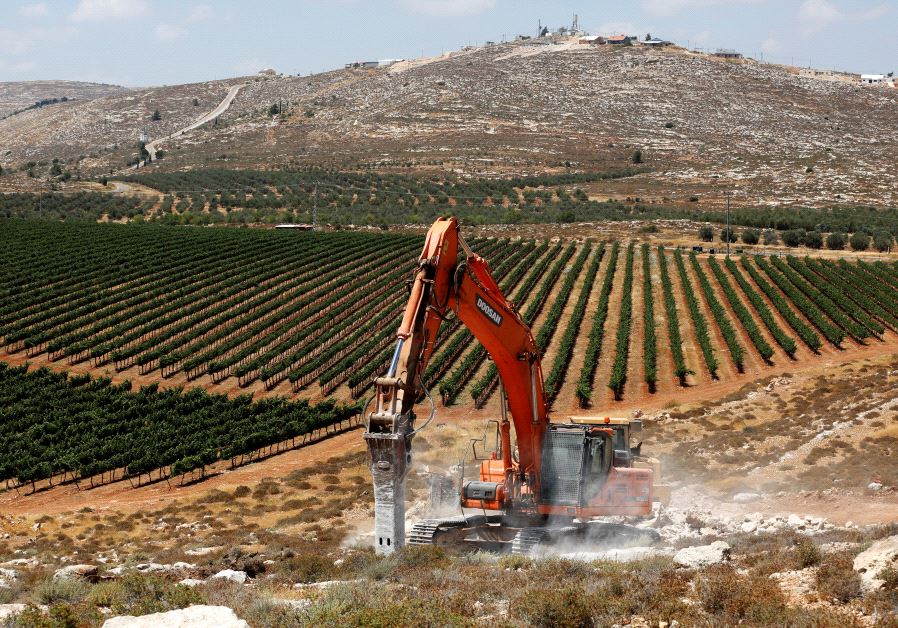 Heavy machinery work on a field as they begin construction work of Amichai, a new settlement.