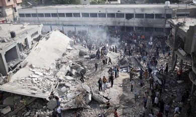 Palestinians at a home destroyed in IAF strike