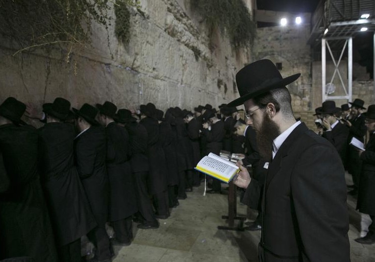 Religious Jews pray at the Western Wall