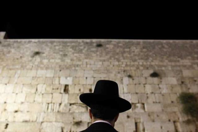 An Orthodox Jewish worshipper prays at the Western Wall, Judaism's holiest prayer site, in Jerusalem's Old City (photo credit: REUTERS)