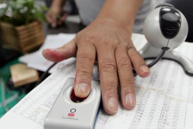 A man has his fingerprint scanned [file] (photo credit: REUTERS)