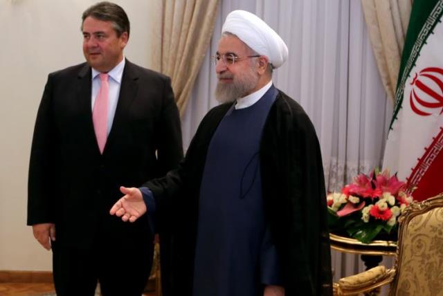 Germany vice chancellor and economic affairs minister Sigmar Gabriel with Iran president Hassan Rouhani (photo credit: ATTA KENARE / AFP)