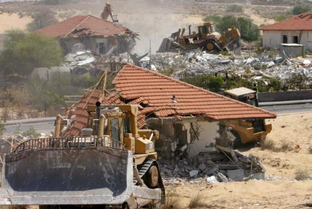 Bulldozers and earthmoving equipment demolish homes in the former Jewish settlement of Neve Dekalim, in the Gaza Strip August 31, 2005.  (photo credit: REUTERS)