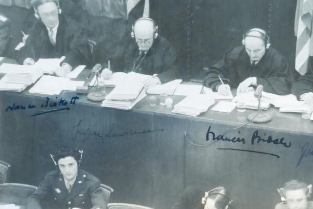 George Sakheim at left, in front of judges at Nuremberg Trial, 1946. The photo was signed by British and American judges (photo credit: COURTESY GEORGE SAKHEIM)