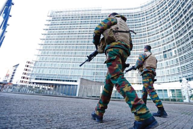 BELGIAN SOLDIERS patrol outside European Commission headquarters in Brussels as police searched the area following the Paris terror attacks in mid-November that claimed the lives of 130 people (photo credit: REUTERS)