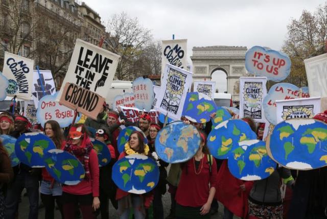 Environmentalists demonstrate near the Arc de Triomphe in Paris, France, as the World Climate Change Conference 2015 (COP21) meets, December 12, 2015 (photo credit: REUTERS)