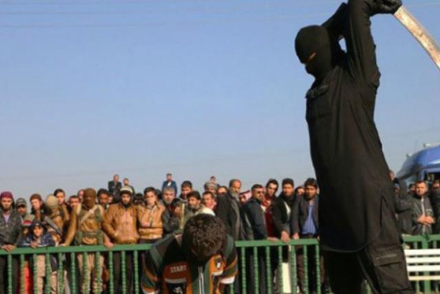 ISIS fighter beheading boy, 16, in Syria (photo credit: ARAB MEDIA)