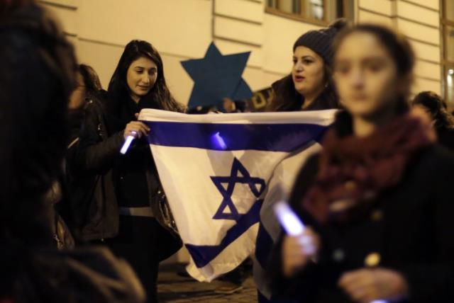 Members of the young Jewish community attend a commemoration ceremony for Holocaust victims in front of the synagogue in Vienna [File] (photo credit: REUTERS)