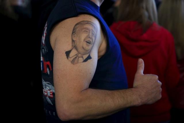 A supporter shows his tattoo before US Republican presidential candidate Donald Trump's campaign rally in Youngstown, Ohio (photo credit: REUTERS)