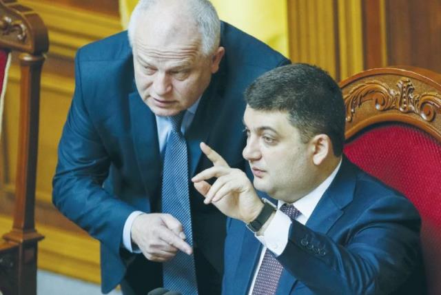 UKRAINIAN PARLIAMENT SPEAKER Volodmyr Groysman (right) speaks with Stepan Kubiv, President Petro Poroshenko’s representative in parliament, during a session in Kiev on March 29. (photo credit: GLEB GARANICH/REUTERS)