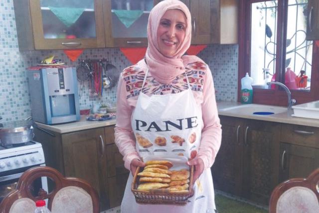 MANAL KARAMAL JEBEREEL, a private caterer, makes iftar meals for families in her home in Umm al-Fahm. (photo credit: LAURA KELLY)