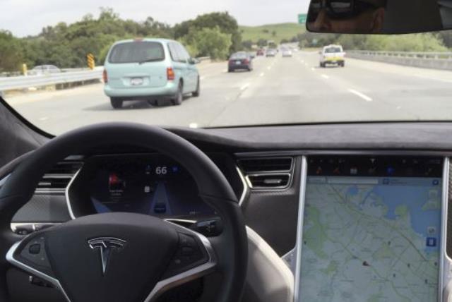 The interior of a Tesla Model S is shown in autopilot mode in San Francisco, California, U.S., April 7, 2016. (photo credit: REUTERS)