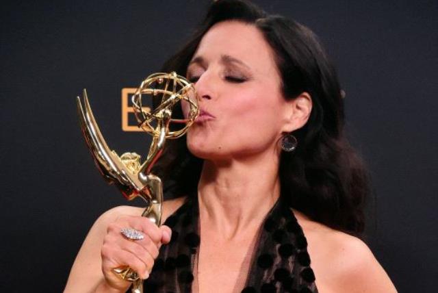 Julia Louis-Dreyfus poses in the press room with the Emmy for Outstanding Lead Actress in a Comedy Series for "Veep"  (photo credit: FREDERIC J BROWN / AFP)