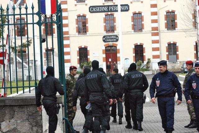 MASKED FRENCH special unit policemen arrive at Perignon barracks after tracking down a terrorist in 2012. (photo credit: REUTERS)