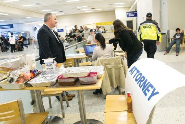 Attorneys volunteer their services at Dallas/Fort Worth International Airport, Texas, earlier this month (photo credit: REUTERS)