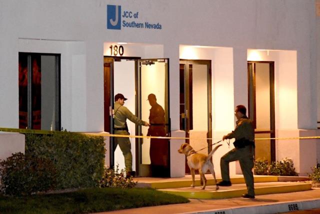  Las Vegas Metropolitan Police Department K-9 officers search the Jewish Community Center of Southern Nevada after an employee received a suspicious phone call that led about 10 people to evacuate the building on February 27, 2017 in Las Vegas, Nevada.  (photo credit: ETHAN MILLER / GETTY IMAGES NORTH AMERICA / AFP)