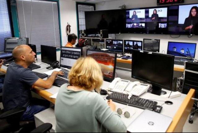 FILE PHOTO: Employees work in the offices of Kan, the new Israeli Public Broadcasting Corporation, in Tel Aviv, Israel November 3, 2016. (photo credit: REUTERS)