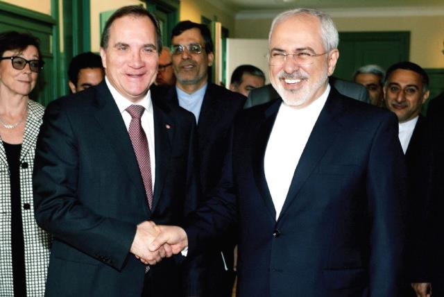 SWEDEN’S PRIME MINISTER Stefan Lofven welcomes Iran’s Foreign Minister Mohammad Javad Zarif at Rosenbad in Stockholm, Sweden last year. (photo credit: REUTERS)