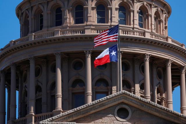 The US and Texas State flags fly over the Texas State Capitol in Austin (photo credit: REUTERS)