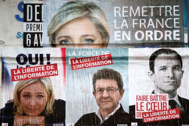 CAMPAIGN POSTERS for candidates Marine Le Pen of the National Front (FN), Jean-Luc Melenchon of the Parti de Gauche, and Benoit Hamon of the Socialist Party who were running in the 2017 French presidential election (photo credit: REUTERS)