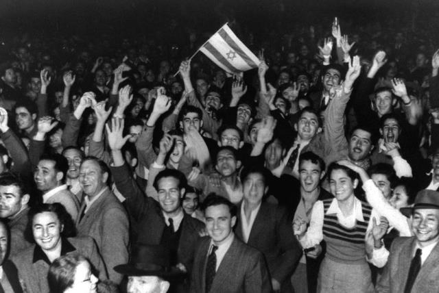 Jews celebrate in the streets of Tel Aviv moments after the United Nations voted on November 29, 1947, to partition Palestine which paved the way for the creation of the State of Israel on May 15, 1948. (photo credit: REUTERS)