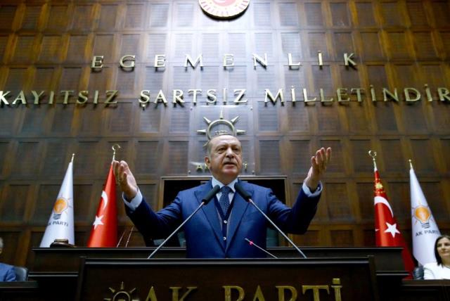 Turkish President Tayyip Erdogan addresses members of parliament from his ruling AK Party (AKP) during a meeting at the Turkish parliament in Ankara, Turkey, June 13, 2017.  (photo credit: KAYHAN OZER/PRESIDENTIAL PALACE/HANDOUT VIA REUTERS)