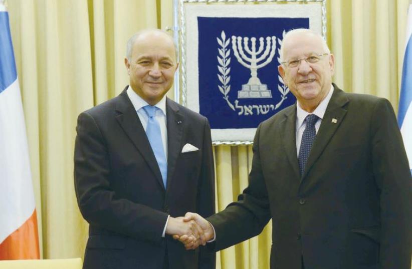 PRESIDENT REUVEN RIVLIN receives French Foreign Minister Laurent Fabius (photo credit: MARK NEYMAN / GPO)