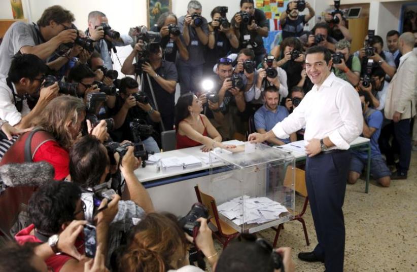 Greek Prime Minister Alexis Tsipras votes at a polling station in Athens, Greece July 5, 2015. (photo credit: REUTERS)