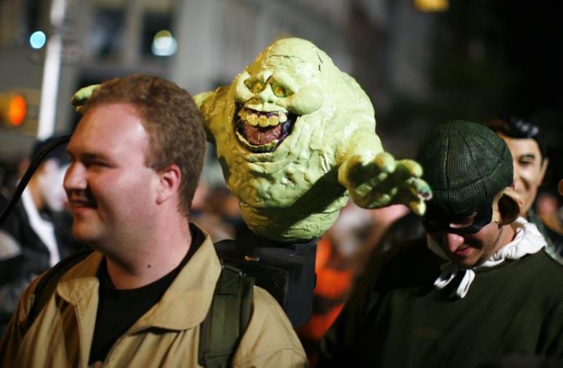 A participant dressed as a character from the show "Ghostbusters" takes part in the annual Greenwich Village Halloween Parade in New York (photo credit: REUTERS)