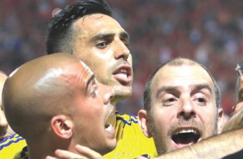 ISRAELI SOCCER made the headlines for all the wrong reasons once again on Monday night, with players from Maccabi Tel Aviv – including Tal Ben-Haim (left) and Eran Zahavi (center) – and Bnei Sakhnin players clashing following a 0-0 draw in Premier League action at Doha Stadium. (photo credit: ERAN LUF)