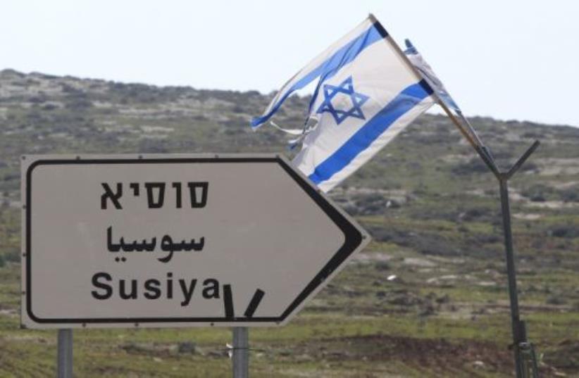 A road sign in English, Hebrew, and Arabic points to the Israeli settlement of Susiya (photo credit: AFP PHOTO)