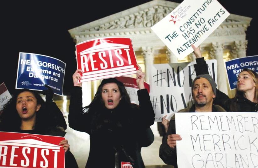 PROTESTERS RALLY outside the US Supreme Court against President Donald Trump’s nominee for the bench, in Washington on Tuesday (photo credit: REUTERS)