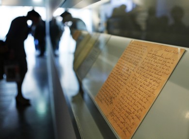 A visitor looks at the pages of Anne Frank