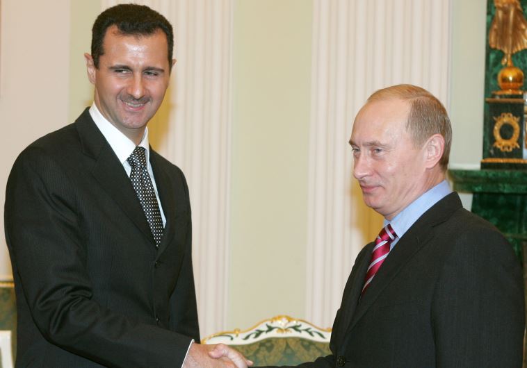 Syrian President Bashar Assad (L) shakes hands with his Russian counterpart Vladimir Putin.