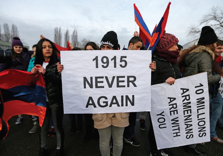 An Armenian protester holds a banner reading ‘1915 never again’ as she takes part in a demonstration near the European Court of Human Rights in Strasbourg in January (credit: REUTERS)
