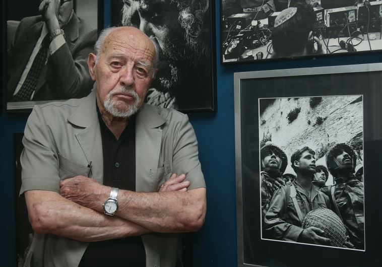 David Rubinger at home, flanked by some of his most iconic photos – including, of course, the June 7, 1967, shot of the three paratroopers at the newly liberated Western Wall (credit: MARC ISRAEL SELLEM)