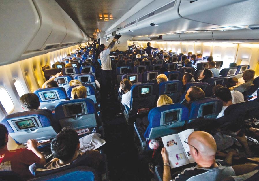 Passengers sitting inside an airplane [illustrative] (credit: Wikimedia Commons)