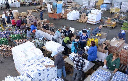 Volunteers put together food packages ahead of the Passover holiday at the Colel Chabad main packaging facility in Kiryat MalachiVolunteers put together food packages ahead of the Passover holiday at the Colel Chabad main packaging facility in Kiryat Malachi (credit: ISRAEL BARDUGO)