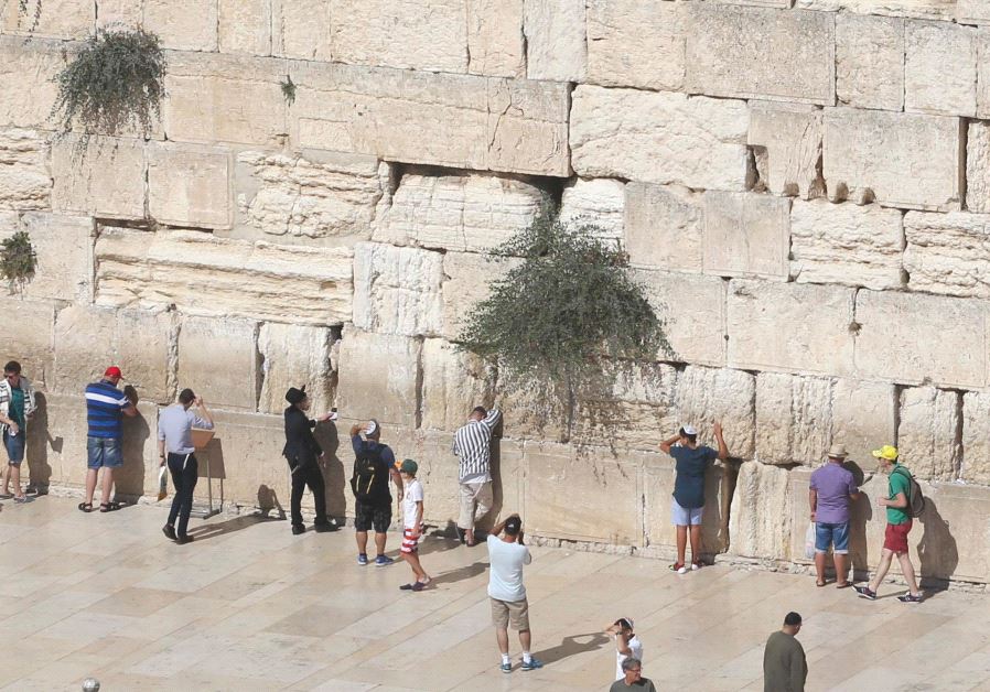 People at the Western Wall in Jerusalem (credit: MARC ISRAEL SELLEM)